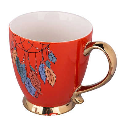 
                                            Экзотическая крупная чашка на ножке с золотой ручкой NBC 400 мл дек. Перья оранжевого цвета.
                                            