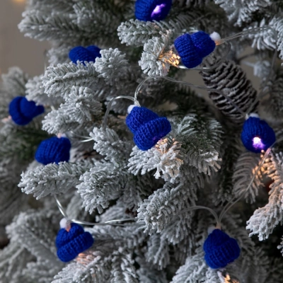 
                                                Blue Cosy Poms garland.
                                                